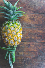 pineapple fruit on wood table
