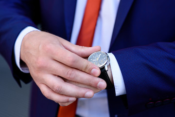 Businessman looks at his watch.