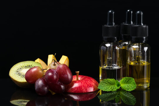 Fruit flavors liquids for electronic cigarettes, concept on a black background