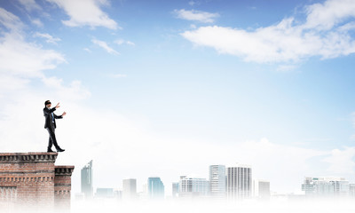 Danger and risk concept with businessman making step from edge