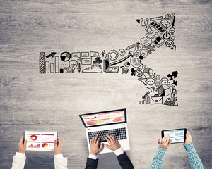 Top view of businesspeople sitting at table and using gadgets