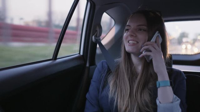 Businesswoman Laughing During a Phone Call in the Car