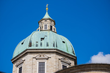 white tower,green roof,gold cross on top