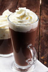 Hot chocolate cocoa with whipped cream on vintage wooden backgro