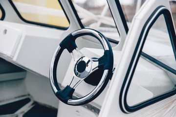 Steering wheel boat, yacht, ship. Expensive finish. Concept travel on water, sea on a yacht.