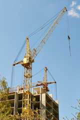Fototapeta na wymiar tower crane on a background of building under construction