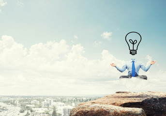 Headless businessman meditating