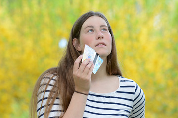 Business woman holding credit cards.
