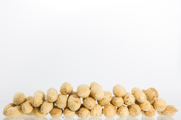 Fototapeta na wymiar Pile of peanuts isolated on white background