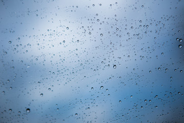 Cold  water drops over glass selective focus background