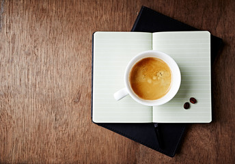 Cup of Coffee on an open Notebook