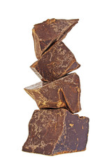 Heap of broken pieces of chocolate on white background