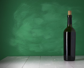 Red wine bottle on a wooden background