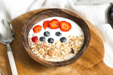 Oatmeal with strawberries and blueberries on a white sheet