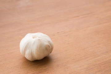 Organic garlic whole and cloves on the wooden background