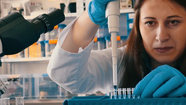 Young woman in microbiological lab