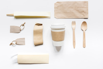 food delivery with paper bags and plastic cup on gray table background top view mockup