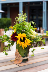 Sunflower and rose the glass jar. Flower decoration. Wedding, party décor. Rose