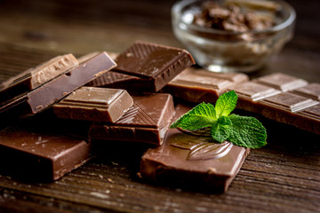 chocolate pieces with mint on wooden table background
