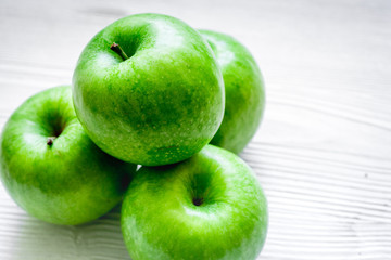 ripe green apples white table background