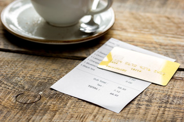 paying check for lunch with card wooden table background