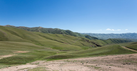 Fototapeta na wymiar Kochkor's green valleys in Kyrgyzstan