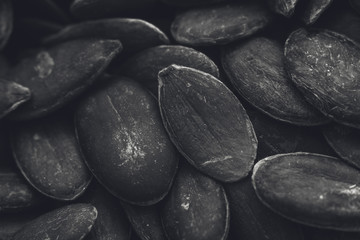  A black and white food background image of pumpkin seeds 