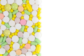 A lot of colorful pills on white background