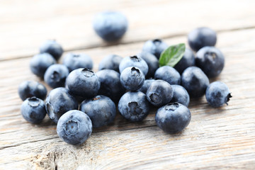 Ripe and tasty blueberries on grey wooden table