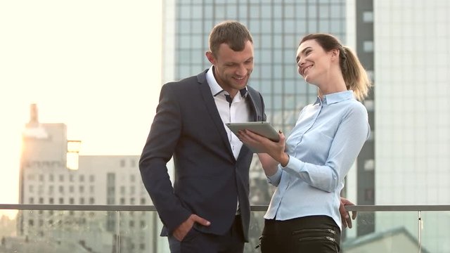 Business people smiling in slow-mo. Woman in shirt holding tablet. What is cooperation.
