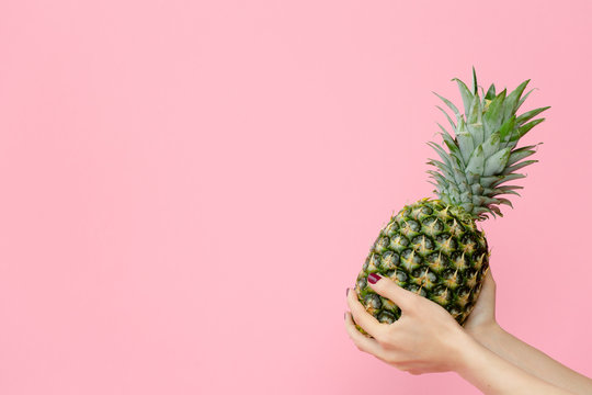Holding pineapple in pick background