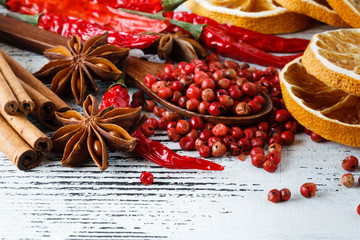 Red chili pepper and rose pepper on wooden background. Selective focus