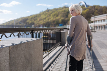 Adult woman enjoying landscapes on the promenade