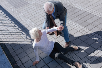 Pleasant woman tumbling over outdoors
