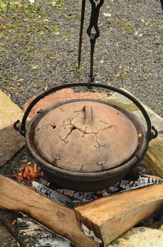 Preparing the goulash in a cettle with clay cover