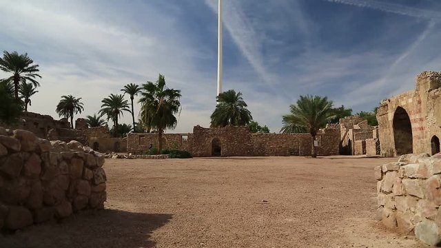Aqaba fort near flag of the Arab Revolt in Aqaba, Jordan. Aqaba Castle, Mamluk Castle or Aqaba Fort, adjacent to fort is archaeological museum. Aqaba - only coastal city in Hashemite Kingdom of Jordan