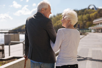 Joyful couple looking at each other in the street