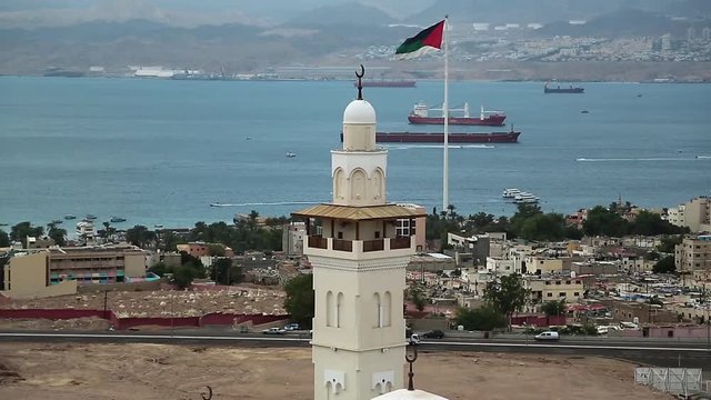 View of the Aqaba city and gulf of Aqaba in Hashemite Kingdom of Jordan and Eilat city in Israel at the distance. View from mountain in Aqaba city, Jordan. Two city and two country in one video clip