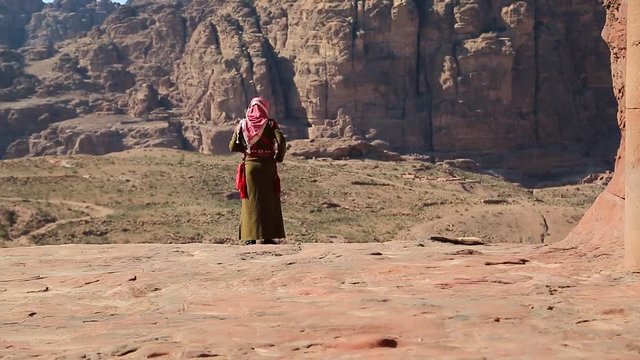 Jordanian in traditional clothes in ancient Petra, originally known to Nabataeans as Raqmu - historical and archaeological city in Hashemite Kingdom of Jordan