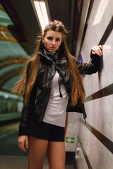 Fashionable young woman in black leather jacket on a background of black and white walls. The urban style. The lobby of the metro Obvodny Kanal, Saint-Petersburg