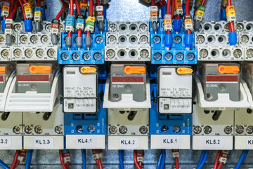 Some electrical relay is mounted on the mounting panel. Relays inserted in the base or socket. To the relay, wires connected with the terminals and marking.