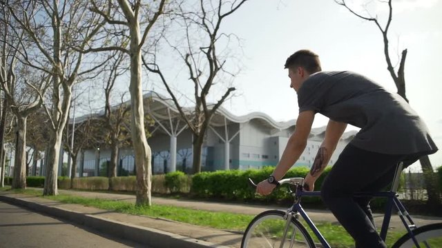 Man riding his bicycle on the street slow motion