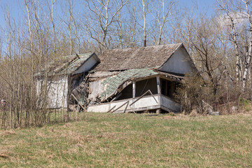 dilapidated house with a collapsed porch