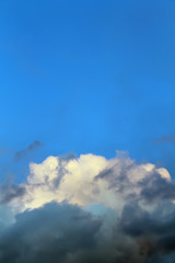 Clean blue sky over a rain cloud with white top