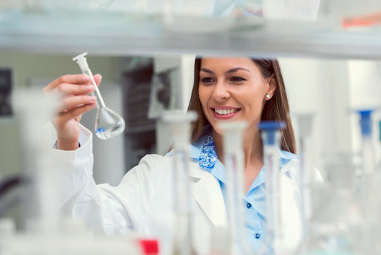 Scientist carrying out experiment in research laboratory. Medical chemist lab.