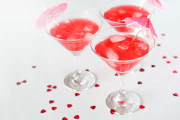 Raspberry cocktail with ice and paper umbrellas