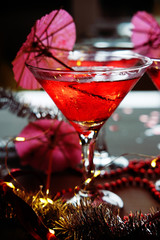 Raspberry cocktail with ice and paper umbrellas