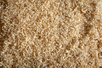 An abstract wood chip background light yellow, sharp at the center and soft at the edges.
