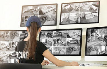 Beautiful security guard in surveillance room
