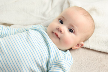 Portrait of adorable baby on light towel